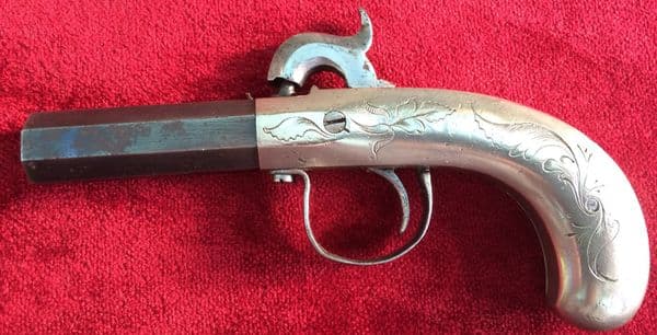 A good American single barrelled Percussion pocket pistol with bag shaped nickel silver grips and frame. Good condition. Ref 8906.